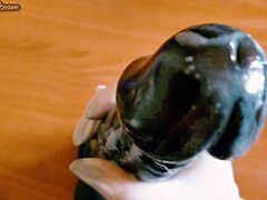 Amateur jerks off a monster black dildo in hot close-up