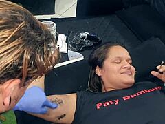 Inked artist gets tattoo of a hot MILF's pussy as a tip